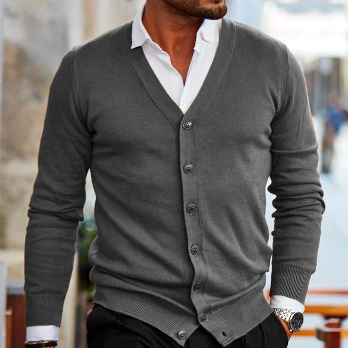 Mann in grauem Cardigan und weißem Hemd, modischer Herrenstil, elegantes Outfit, urbane Mode, stilvolle Herrenbekleidung, Freizeitlook.