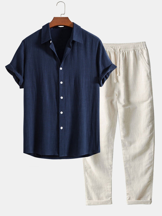 Dunkelblaues Kurzarmhemd und beige Leinenhose auf Kleiderbügel, lässige Sommermode, Herrenbekleidung, stilvolles Outfit, minimalistisch.