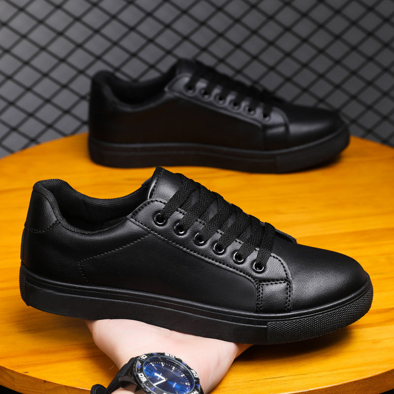 Schwarze Ledersneaker auf Holztisch, modernes Design, Schnürsenkel, sportlich-elegant, ideal für Freizeit und Alltag, Unisex-Schuhe.