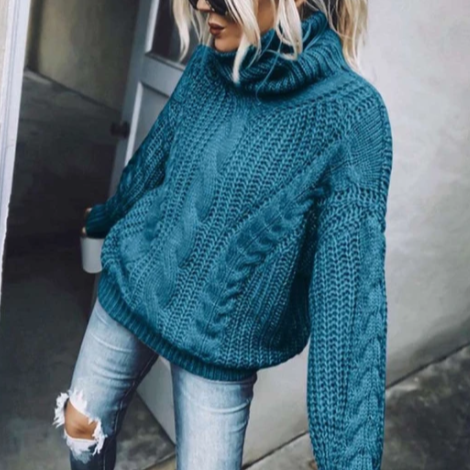 Frau in blauem Strickpullover und zerrissenen Jeans, modisch, lässig, Herbstmode, Streetstyle, trendige Damenbekleidung, gemütlicher Look.