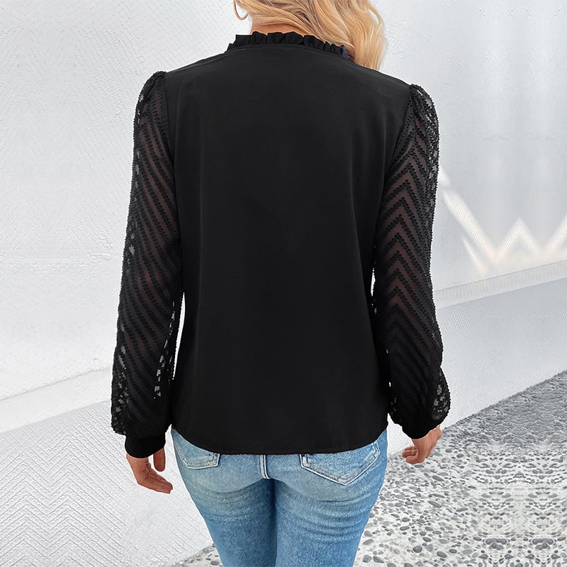 Frau in schwarzer Bluse mit Spitzenärmeln und blauen Jeans, Rückansicht. Modetrend, elegante Damenbekleidung, stilvolle Freizeitmode.