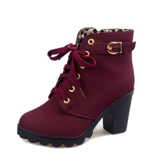 Women's Martin boots with cross straps, suede upper material, and rubber sole