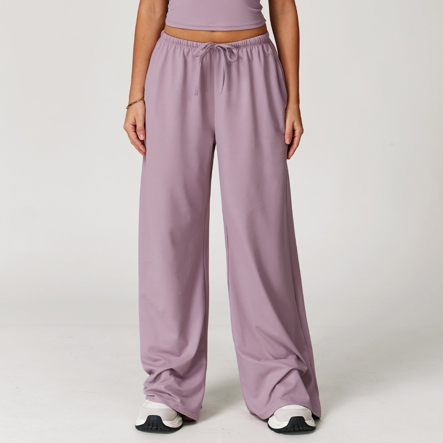 Wide women's pants made of brushed leather with high waist and pendant