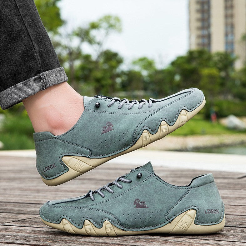 Grüne Freizeitschuhe aus Leder mit markanter Sohle, getragen im Freien. Stilvolle Herrenschuhe, ideal für lässige Outfits und Spaziergänge.