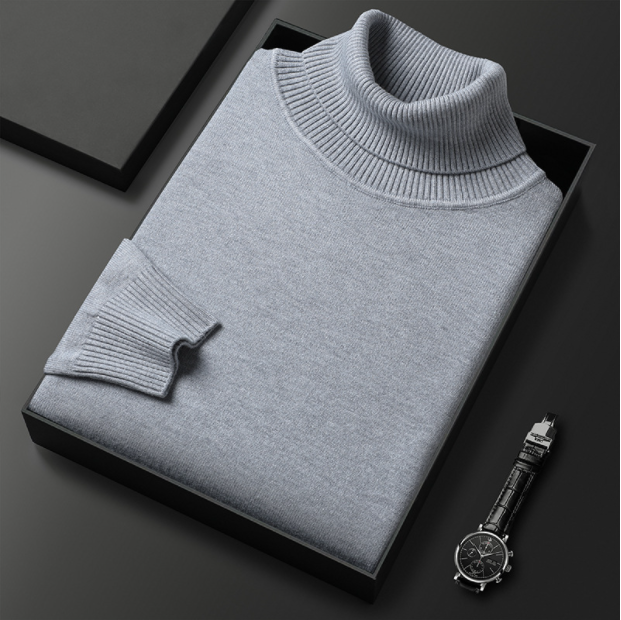 Grauer Rollkragenpullover aus Kaschmir in schwarzer Geschenkbox, daneben eine elegante Armbanduhr. Luxuriöse Herrenmode, stilvolles Design.