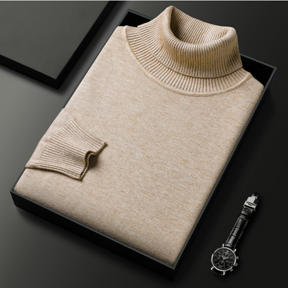 Beigefarbener Rollkragenpullover aus Kaschmir in schwarzer Geschenkbox, daneben eine elegante schwarze Armbanduhr auf dunklem Hintergrund.