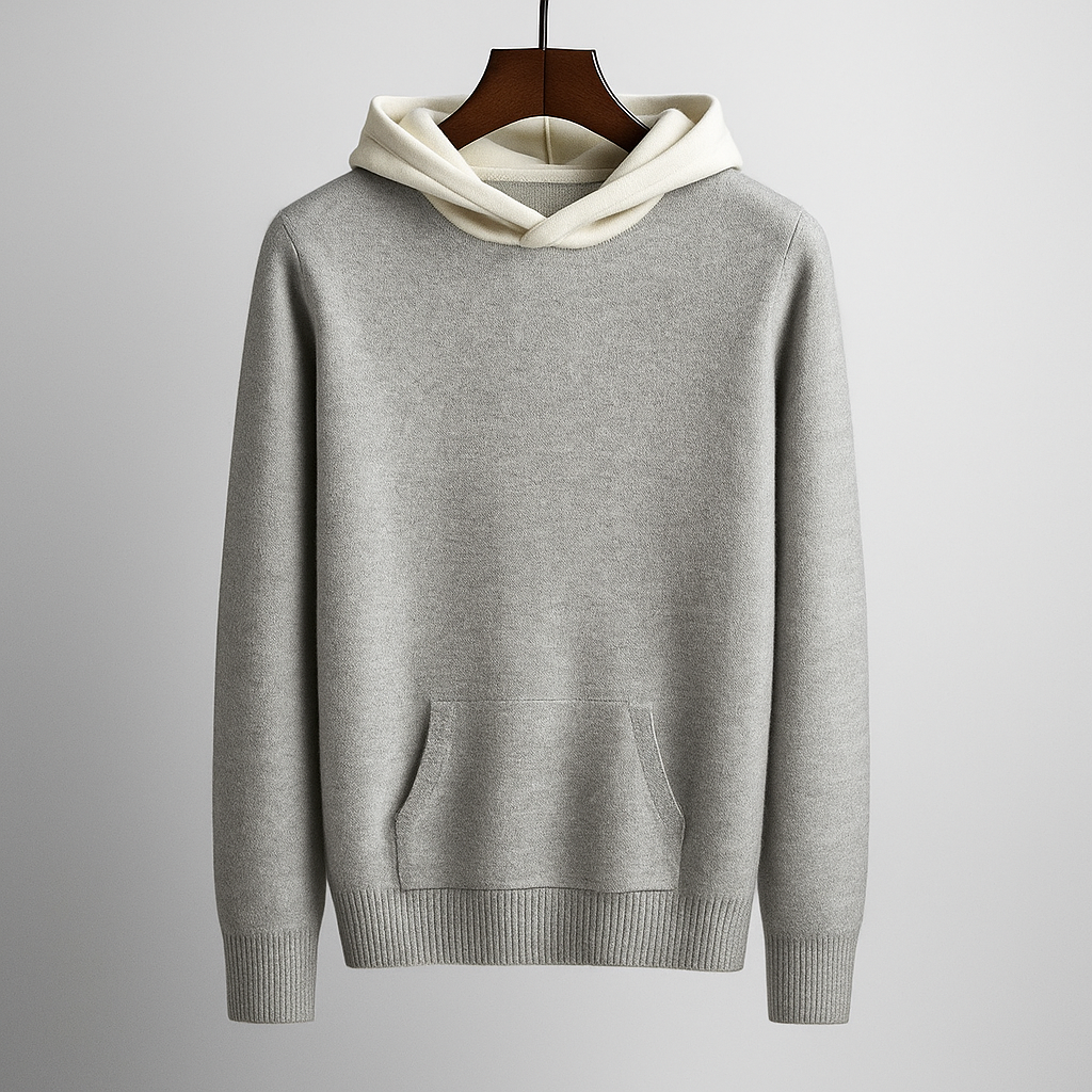 Grauer Kapuzenpullover aus Baumwolle mit Kängurutasche, auf Holzbügel hängend. Modischer Hoodie für Herren, ideal für Freizeit und Sport.