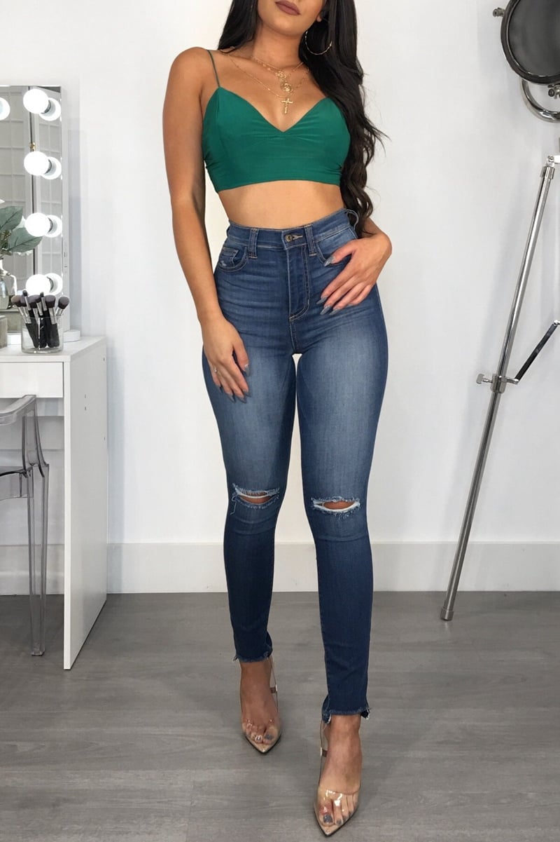 Women's jeans with mid-rise waist, slim fit, and hip lifting made from cotton blend fabric