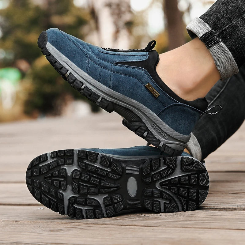 Blaue Outdoor-Sneaker mit rutschfester Sohle auf Holzweg. Bequeme, sportliche Schuhe für Herren, ideal für Wandern und Freizeitaktivitäten.