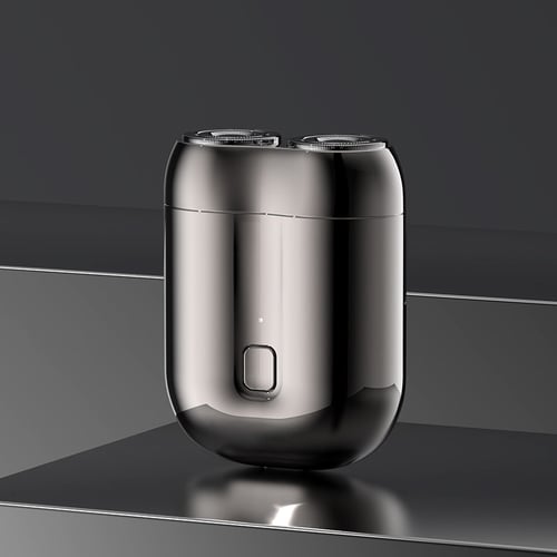 Schwarzer elektrischer Rasierer mit zwei Scherköpfen auf reflektierendem Untergrund, modernes Design, ideal für präzise Rasur und Pflege.