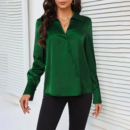 Grüne Damenbluse aus Satin, langärmlig, mit Knopfleiste, kombiniert mit schwarzer Hose. Elegante Mode für Büro und Freizeit.
