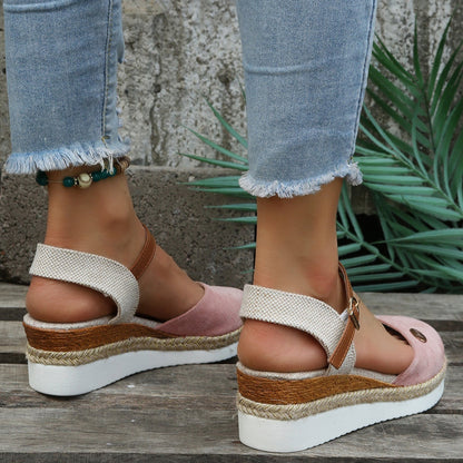 Damen Sandalen mit Keilabsatz, rosa Wildleder, geflochtene Sohle, lässiger Sommerstil, kombiniert mit hellblauen Jeans, Outdoor-Hintergrund.