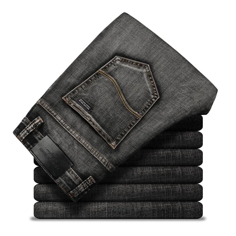 Gestapelte schwarze Jeans mit sichtbarer Gesäßtasche und Etikett, modisch und robust, ideal für Herrenmode und Freizeitkleidung.