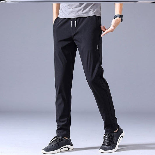 Graue Sporthose für Herren, lässig und bequem, mit elastischem Bund und Kordelzug, ideal für Fitness und Freizeit.