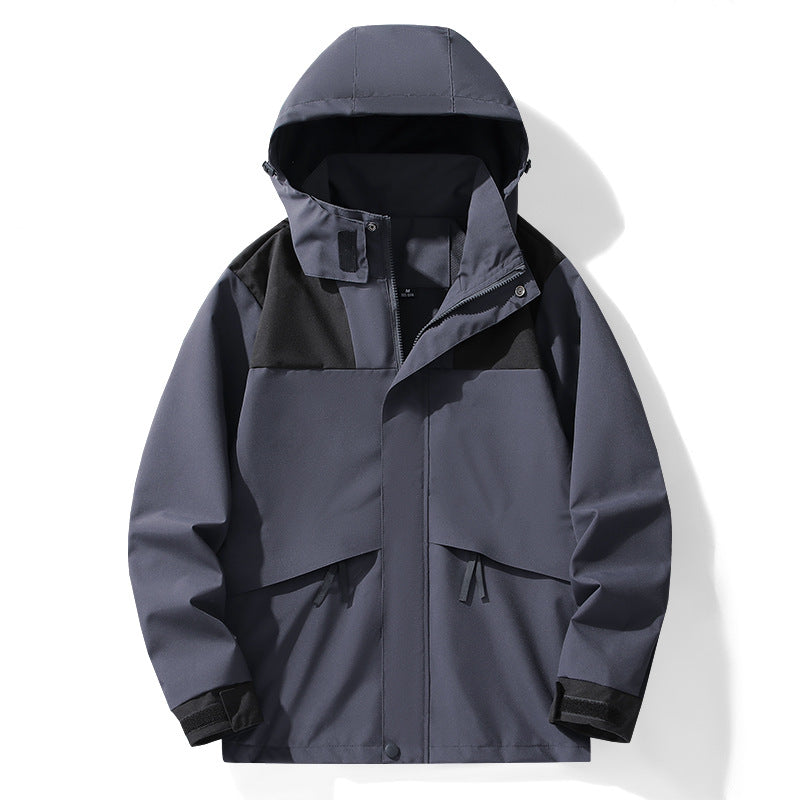 Graue Outdoor-Jacke mit Kapuze, wasserdicht und winddicht, ideal für Herren. Funktionale Taschen, modernes Design, perfekt für Wandern und Trekking.