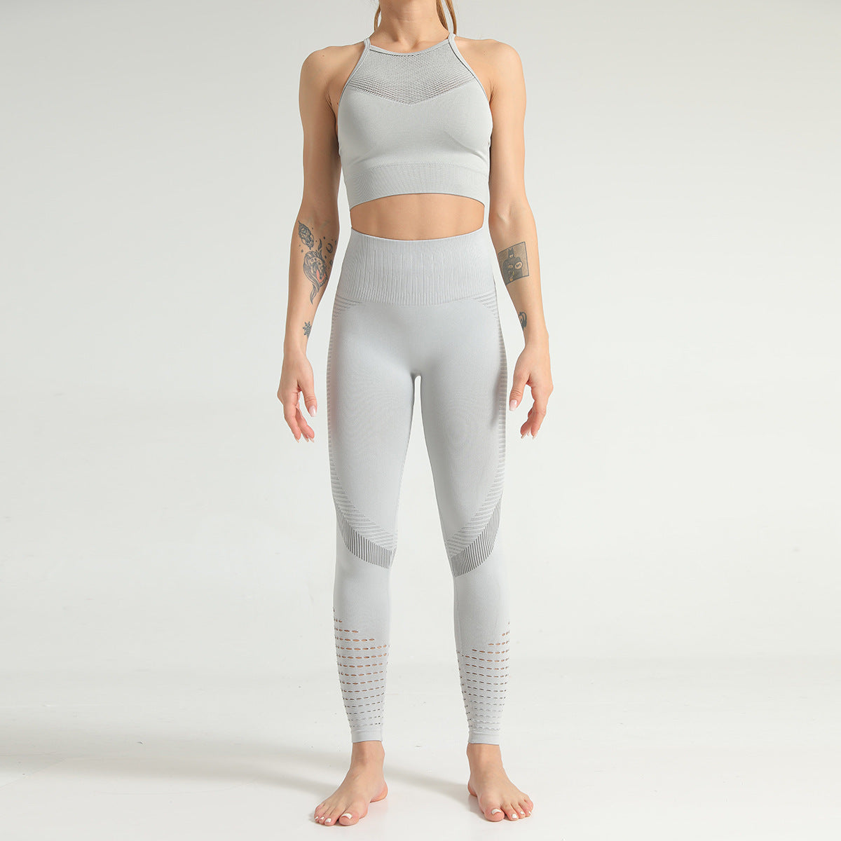 Frau in grauem nahtlosem Sport-BH und Leggings, Fitnessmode, athletische Kleidung, Yoga-Outfit, bequeme Sportbekleidung, Ganzkörperansicht.