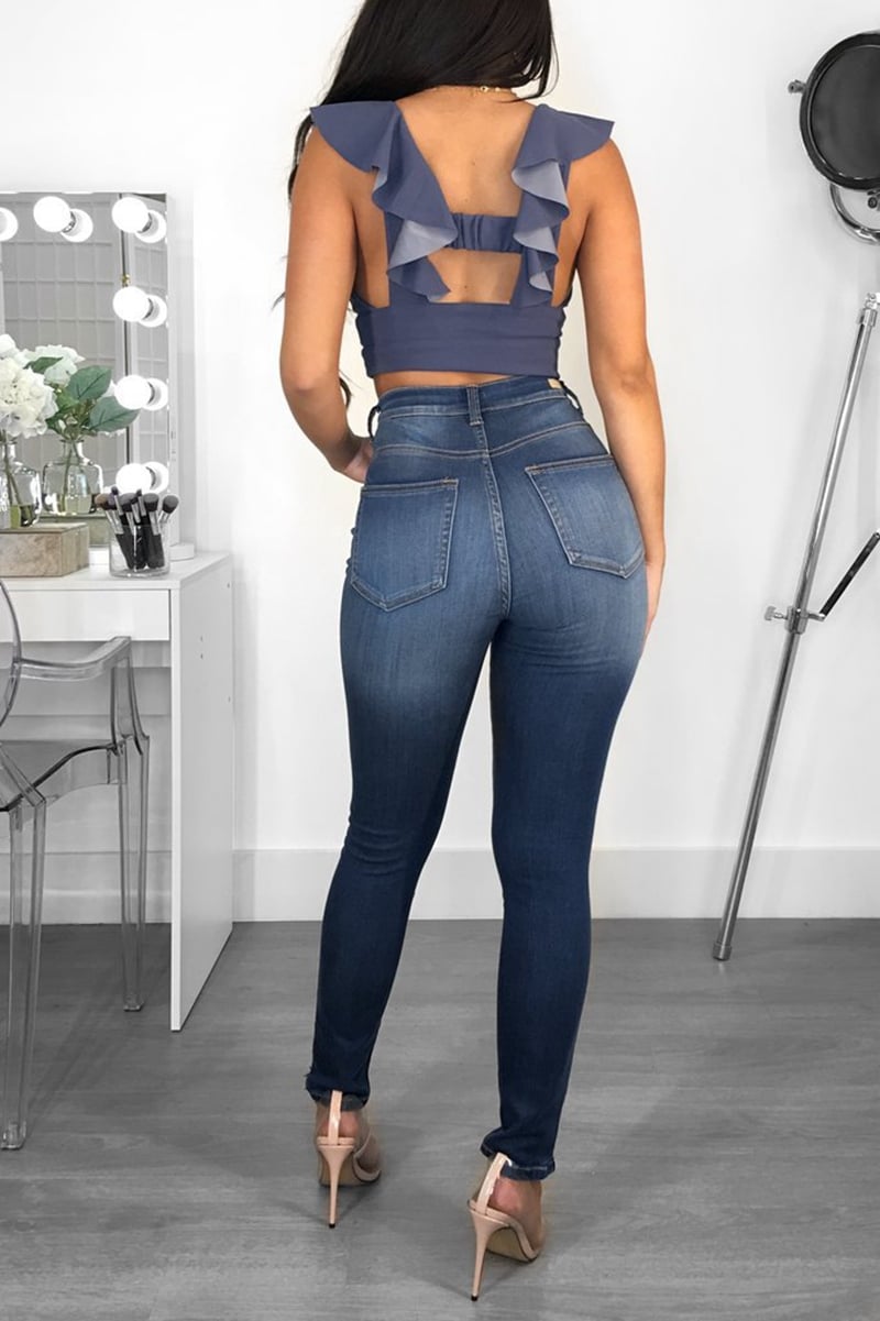 Women's jeans with mid-rise waist, slim fit, and hip lifting made from cotton blend fabric
