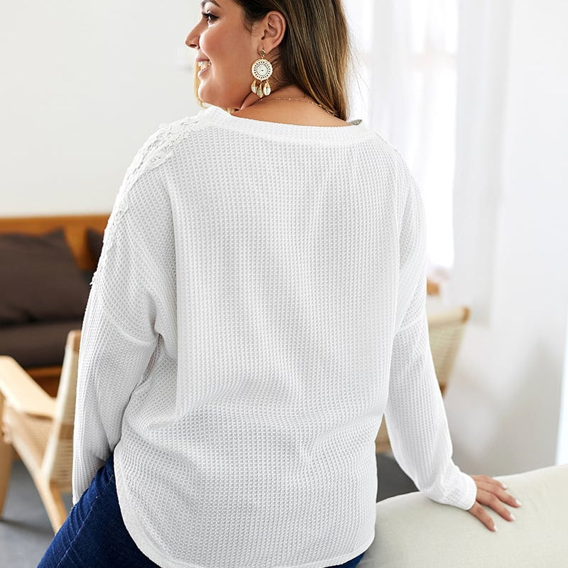 Women's knitted sweater with V-neck, long sleeves, and button details