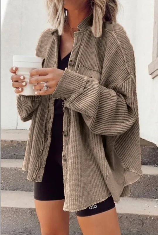 Women's shirt jacket with notch collar, front pockets, and asymmetrical hem
