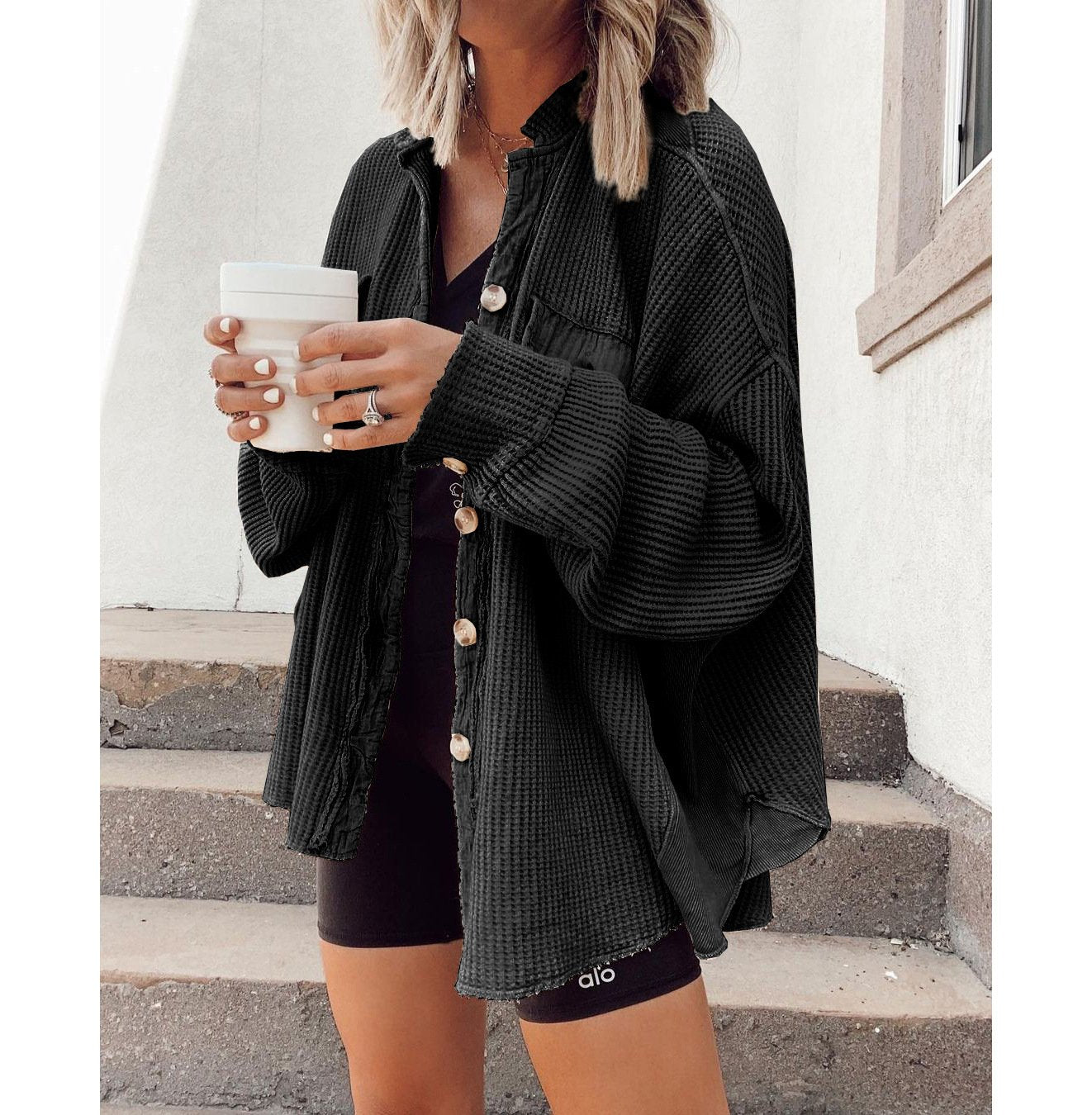 Women's shirt jacket with notch collar, front pockets, and asymmetrical hem