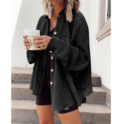 Women's shirt jacket with notch collar, front pockets, and asymmetrical hem