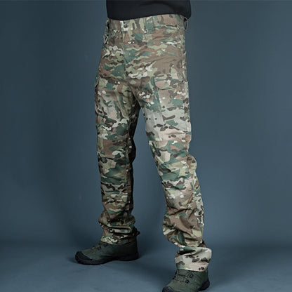 Tarnhose in Multicam-Muster, getragen von einer Person, vor grauem Hintergrund. Ideal für Outdoor-Aktivitäten, Jagd und taktische Einsätze.