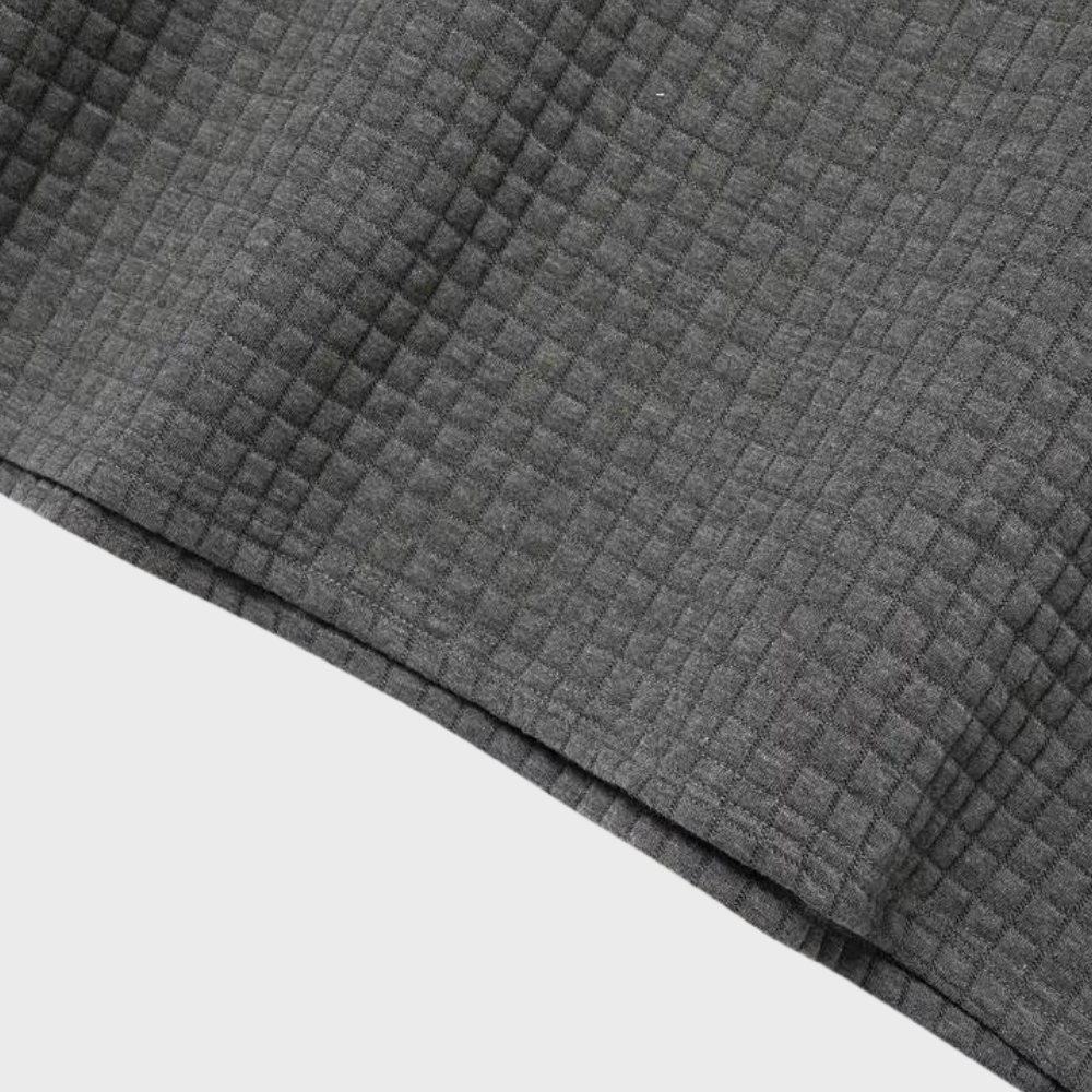 Grauer, kariert strukturierter Stoff, Nahaufnahme. Ideal für Mode, Textilien, Heimdekoration. Hochwertiges Material, vielseitig einsetzbar.