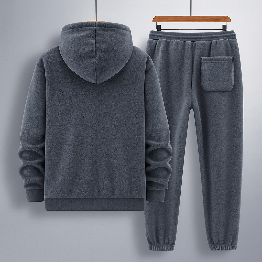Grauer Fleece-Trainingsanzug mit Kapuzenpullover und Jogginghose, hängend auf Holzkleiderbügeln. Bequeme Freizeitmode für Herren.