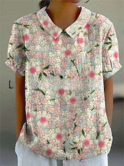 Damenbluse mit Blumenmuster, kurzärmelig, Kragen, pastellfarbene Blumen, lässiger Stil, ideal für Sommermode, modisches Design.