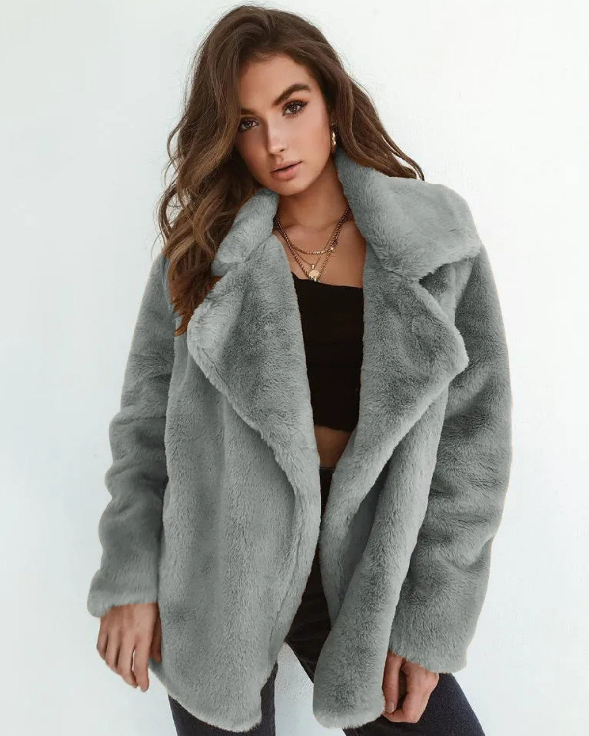 Frau in grauem Kunstpelzmantel, modisch, elegant, Wintermode, Damenbekleidung, trendiger Look, stilvolle Jacke, lässiger Chic.