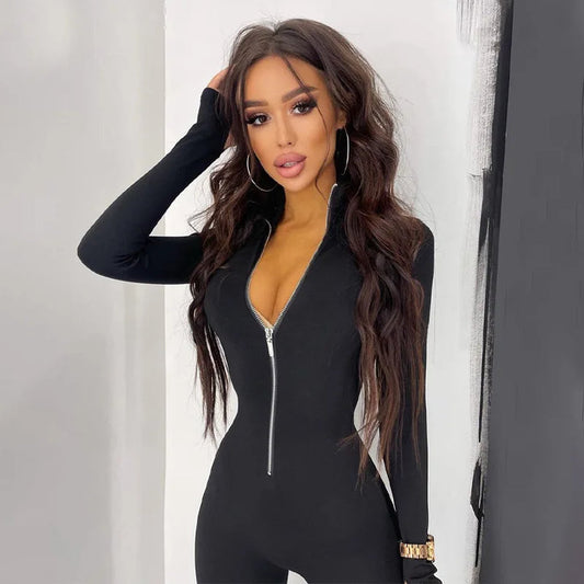 Frau in schwarzem, langärmligem Jumpsuit mit Reißverschluss, lange braune Haare, modisch, elegant, Studioaufnahme, trendige Damenmode.