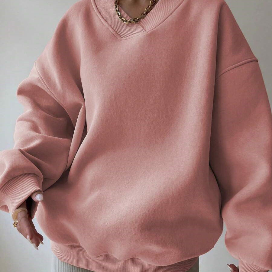Damen Oversize Pullover in Rosa, V-Ausschnitt, lässiger Stil, modisches Design, ideal für Herbstmode, bequem und stilvoll.