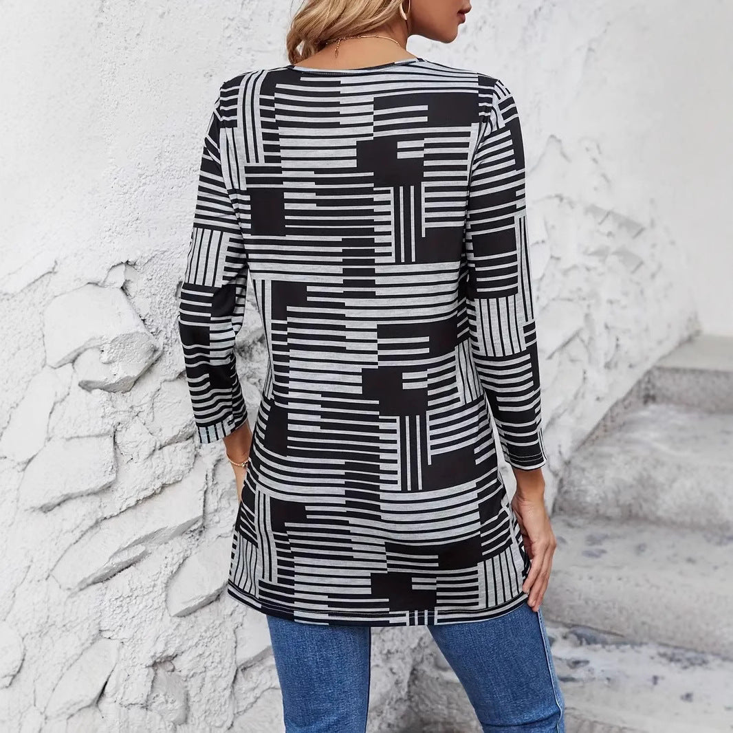 Frau in schwarz-weiß gestreiftem Langarmshirt, geometrisches Muster, Rückansicht, lässiger Stil, kombiniert mit blauen Jeans, vor weißer Wand.