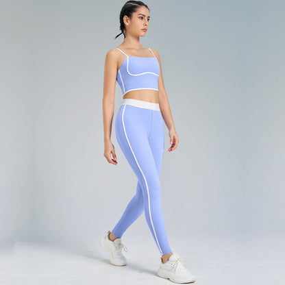 Frau in blauer Sportbekleidung, bestehend aus Leggings und Top, beim Gehen. Fitnessmode, Sportoutfit, aktive Kleidung, Studiohintergrund.