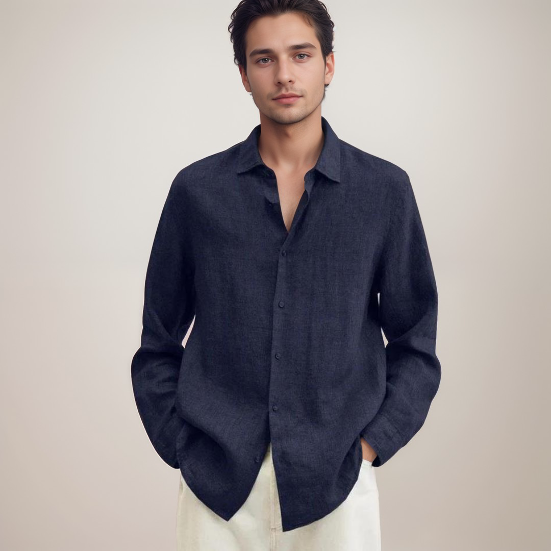 Junger Mann in dunkelblauem Hemd und weißer Hose vor neutralem Hintergrund. Mode, Herrenbekleidung, eleganter Stil, Freizeitlook.