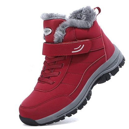 Roter Winterstiefel mit grauem Kunstfellfutter, Klettverschluss und rutschfester Sohle. Ideal für Outdoor-Aktivitäten und kaltes Wetter.