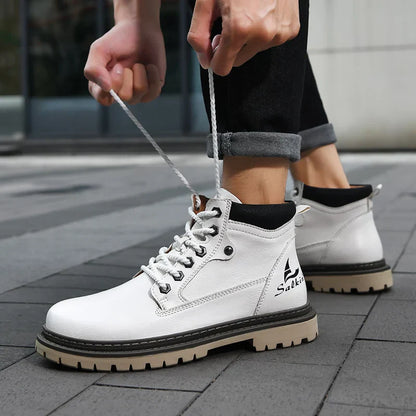 Weiße Herrenstiefel mit Schnürsenkeln, robustem Profil und schwarzem Kragen, getragen auf grauem Pflaster. Ideal für Outdoor und urbanen Stil.