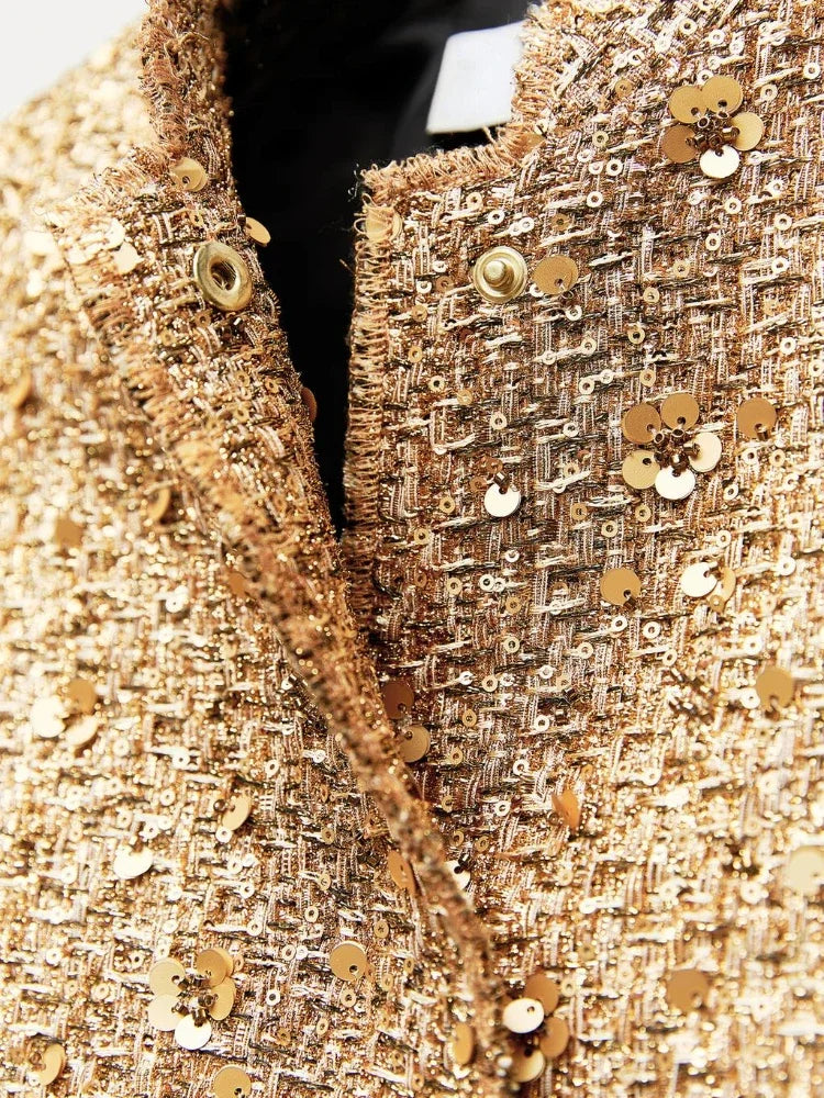 Goldene Paillettenjacke aus Tweed mit Blumenmuster, Nahaufnahme. Luxusmode, glamouröse Damenbekleidung, elegantes Design.