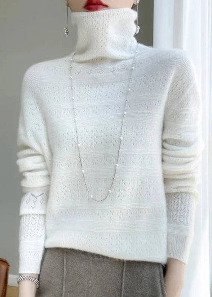 Frau in weißem Strickpullover mit Rollkragen und langer Halskette, elegantes Winteroutfit, modisch, gemütlich, stilvoll, Damenmode.
