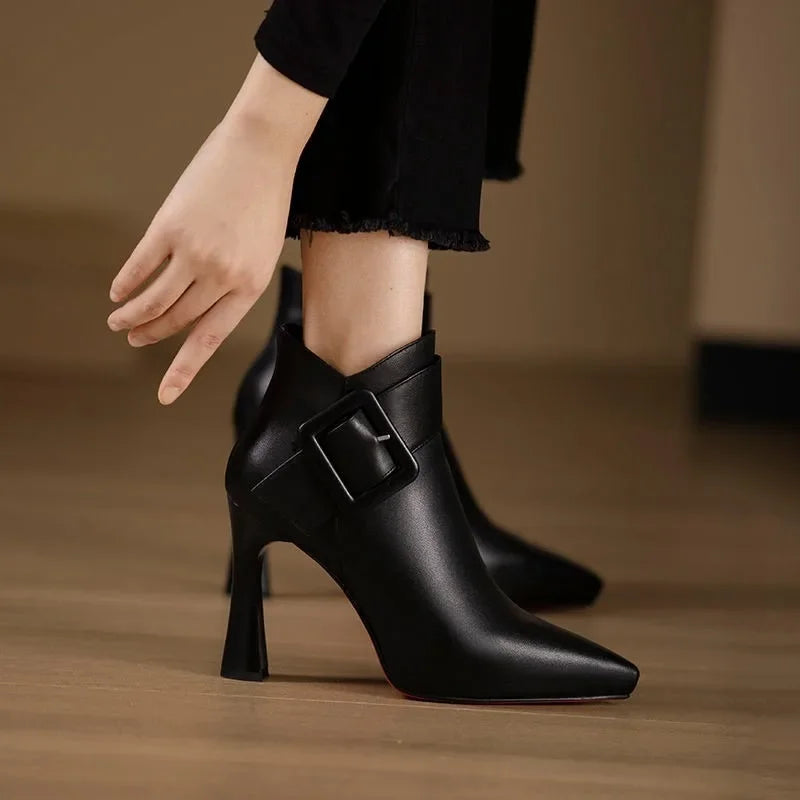 Women's ankle boots with heel, buckle strap, and pointed toe area