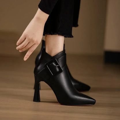 Women's ankle boots with heel, buckle strap, and pointed toe area