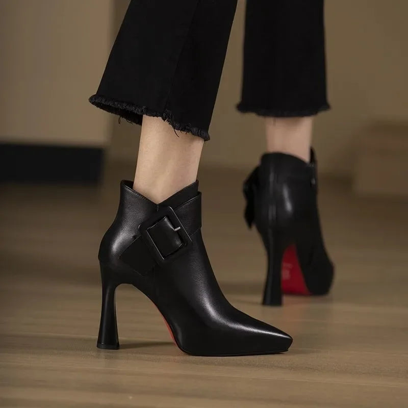 Women's ankle boots with heel, buckle strap, and pointed toe area