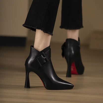 Women's ankle boots with heel, buckle strap, and pointed toe area