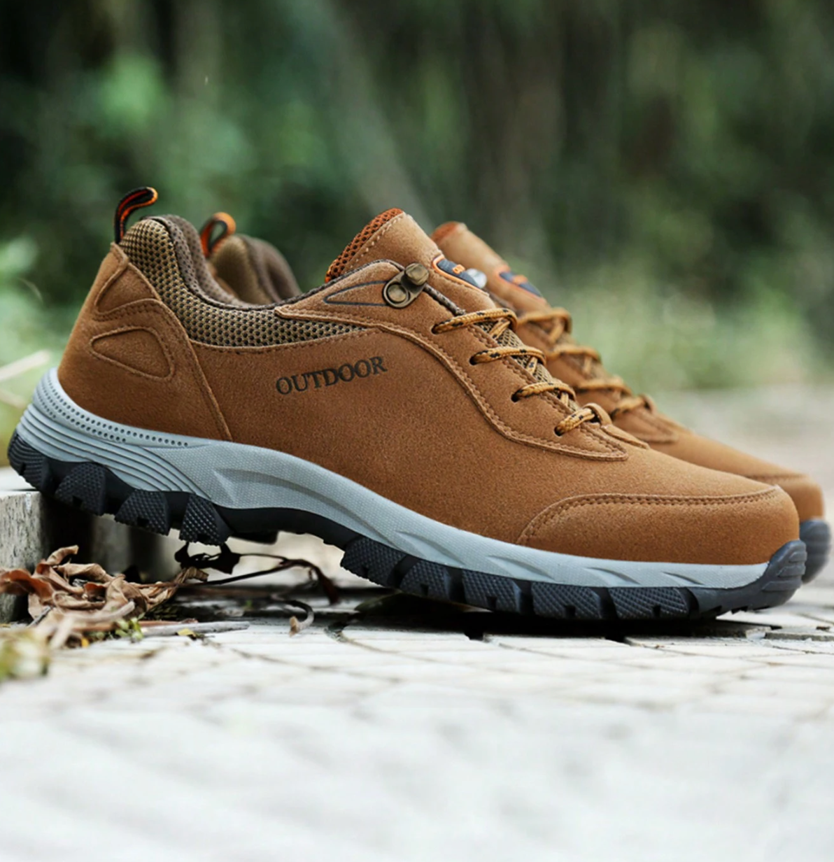 Braune Outdoor-Wanderschuhe mit robustem Profil auf Waldweg. Ideal für Trekking und Naturabenteuer. Bequeme, rutschfeste Sohlen.