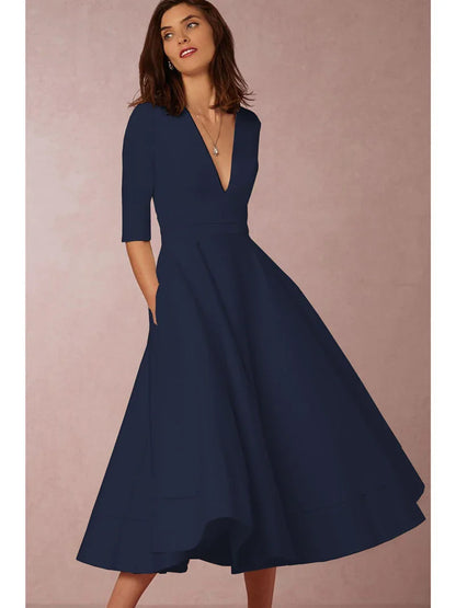 Frau in elegantem, dunkelblauem Kleid mit V-Ausschnitt und halblangen Ärmeln, stehend vor neutralem Hintergrund. Mode, Damenkleidung, Abendkleid.