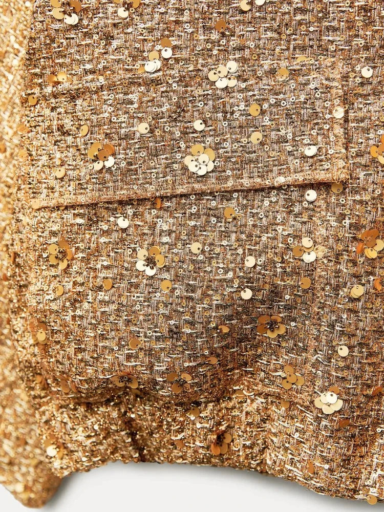 Goldene Paillettenjacke aus Tweed mit funkelnden Details, modisch und elegant, ideal für glamouröse Anlässe und stilvolle Outfits.