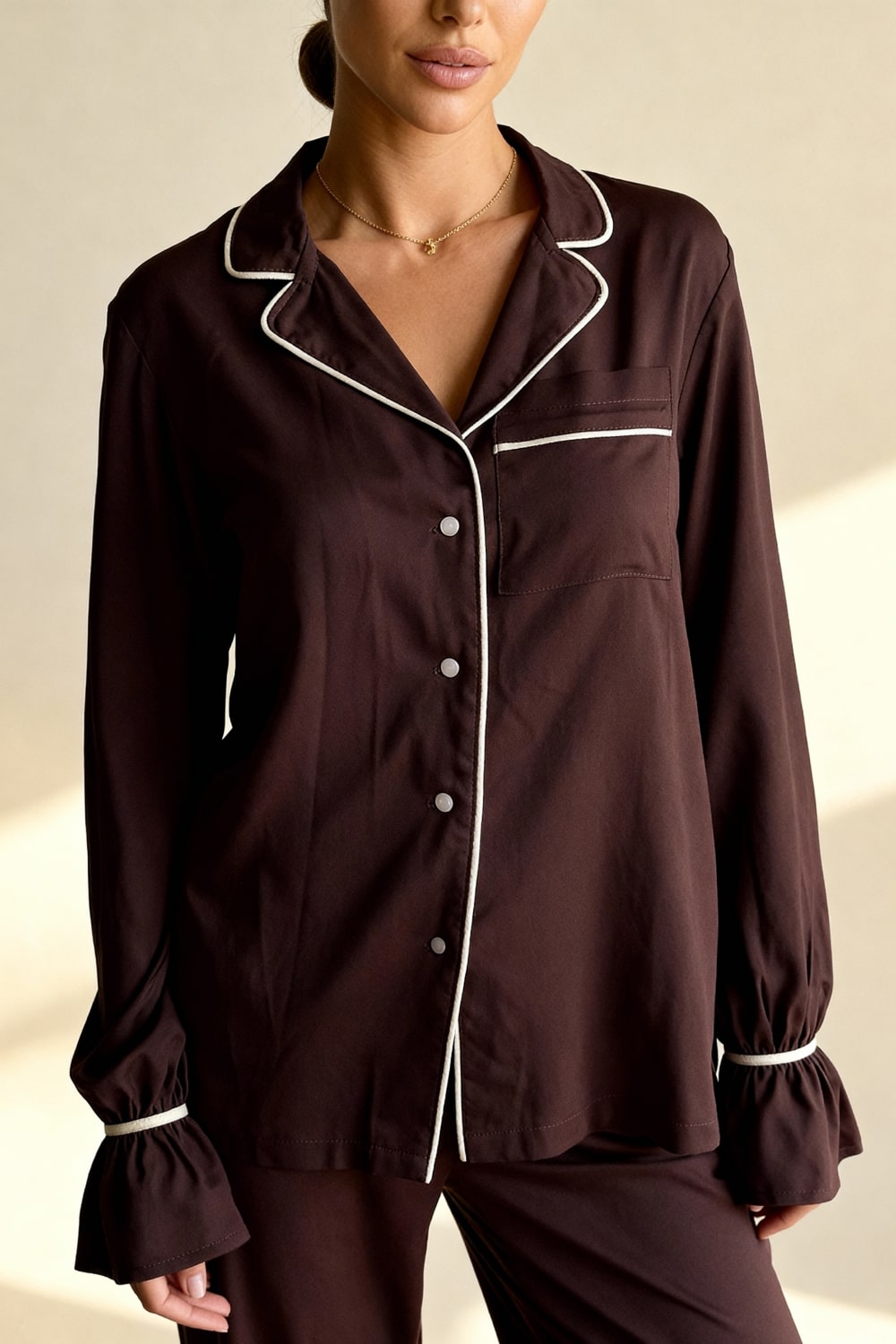 Women's pajama set with flowing top featuring a notched collar and flared sleeves