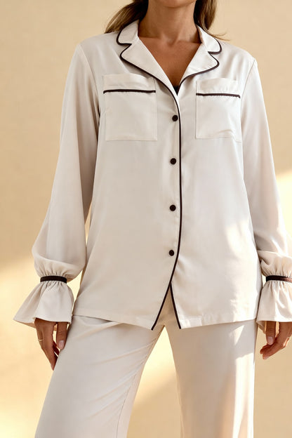 Women's pajama set with flowing top featuring a notched collar and flared sleeves