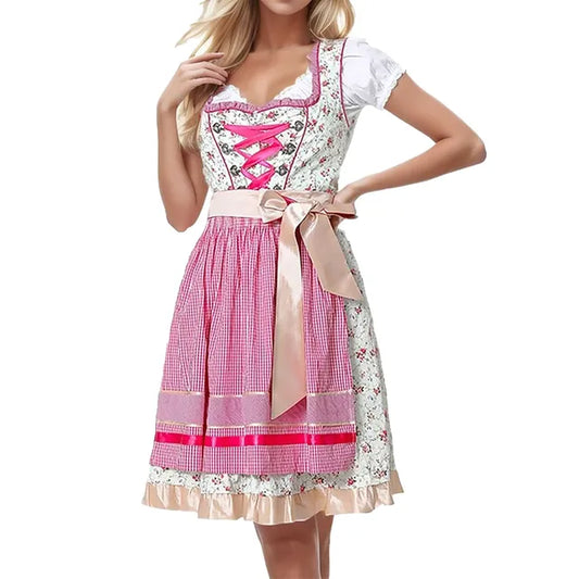 Frau in traditionellem bayerischen Dirndl mit rosa Schürze und Blumenmuster, Oktoberfest Trachtenmode, festliche Damenbekleidung.