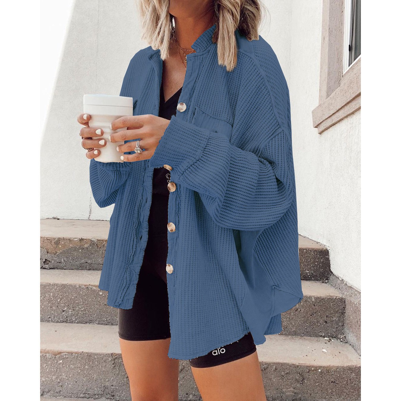 Women's shirt jacket with notch collar, front pockets, and asymmetrical hem